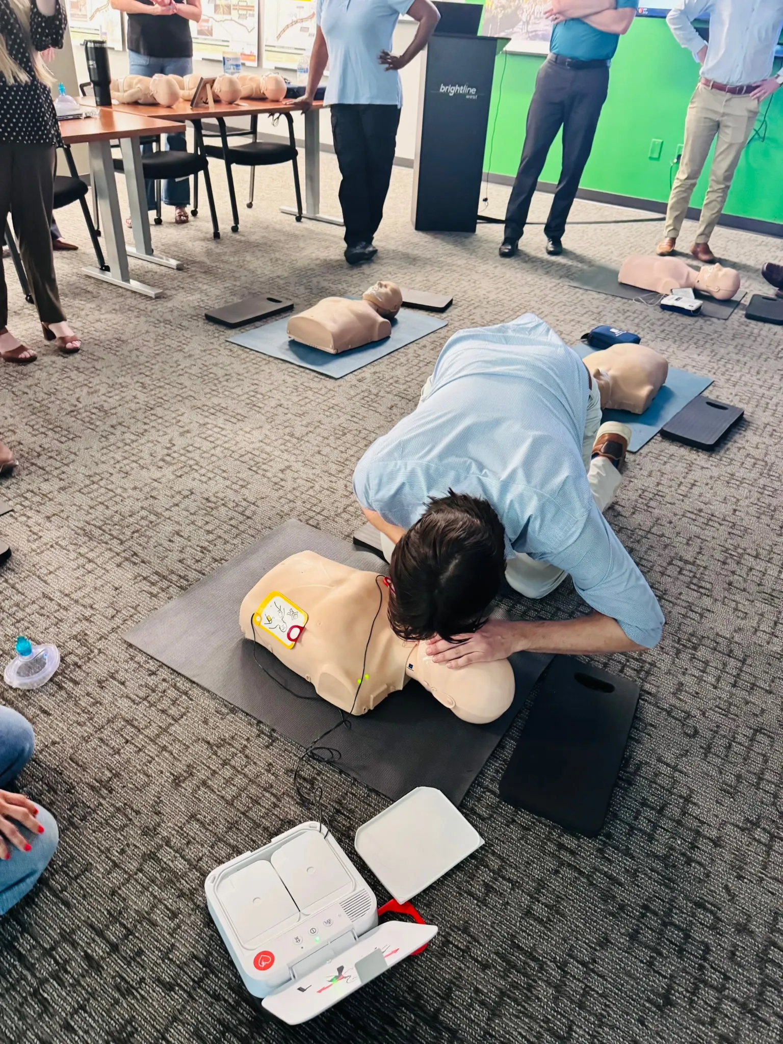 Hands-on CPR chest-compression practice on a training manikin with an AED in a Las Vegas class